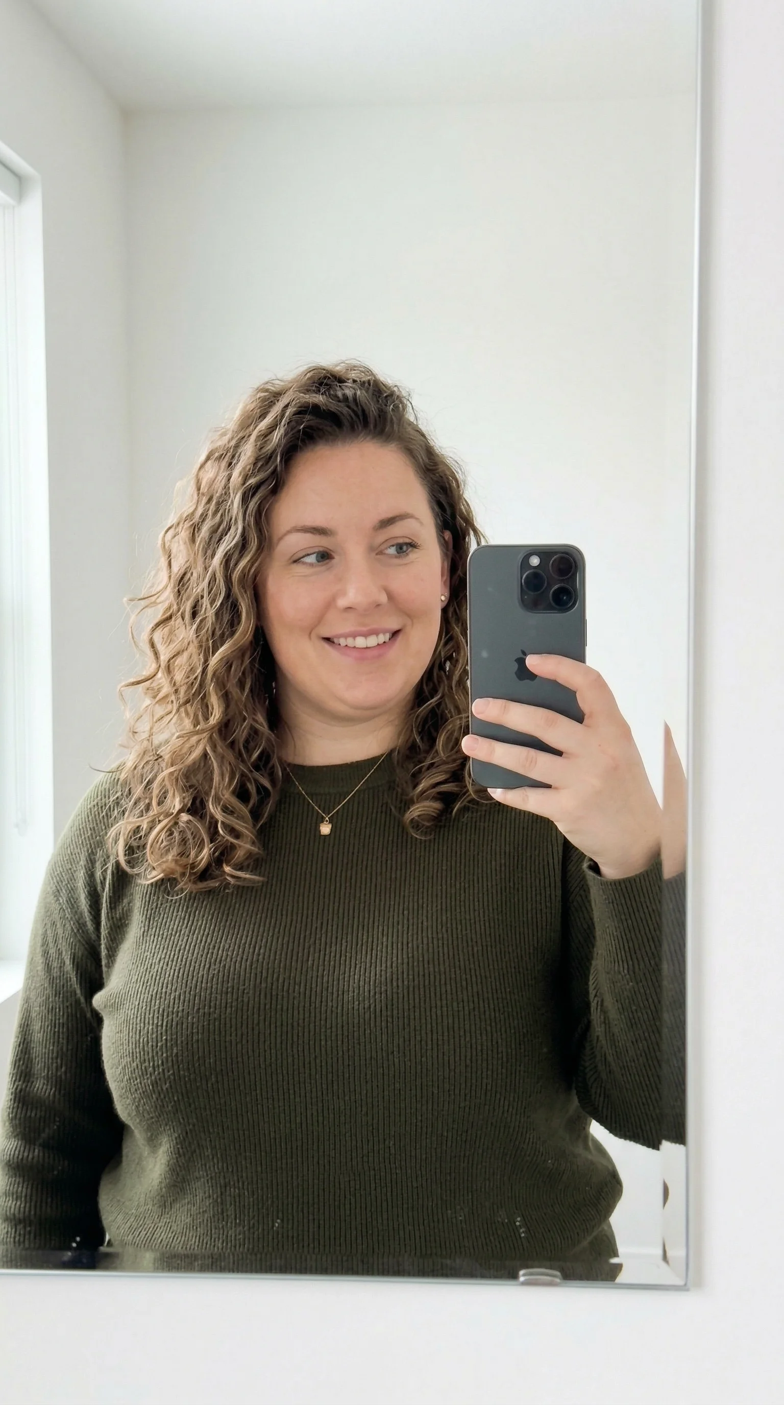 Progress photo in a green sweater